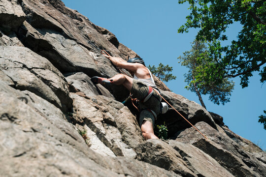 man on an outdoor climbing wall on a sunny day in Stockholm