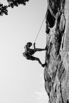 man walking down the rock after outdoor climbing with his friend