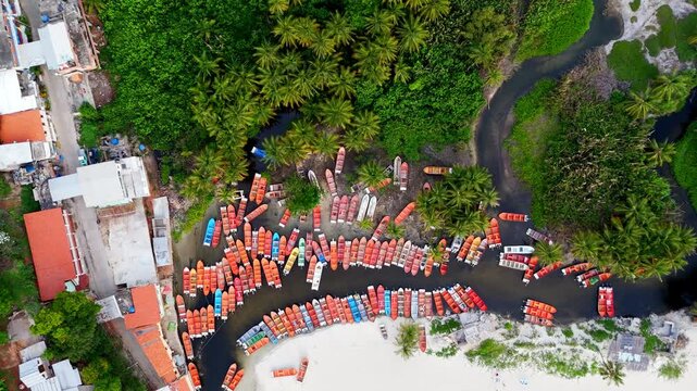 Aerial top view down of a Caribbean paradise beach with a river channel and fishing boats