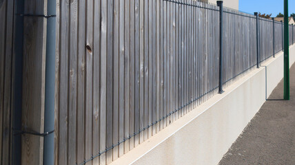 wall raw wooden fence high slim planks barrier modern house protect view access home garden