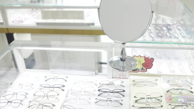A rows of eyeglasses on display in a shop. stand with glasses in an optics store. Eyesight correction.
