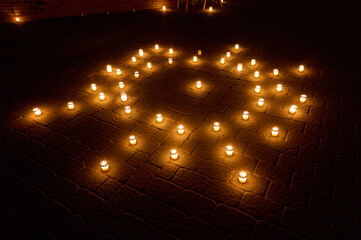 Evening Candle Arrangement Sparkles on Cobblestone Patio Illuminating Serenity