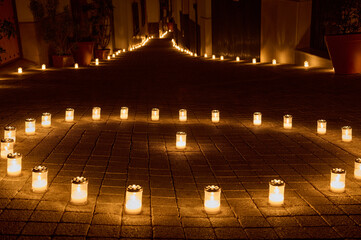 Candlelit Pathway Illuminating a Peaceful Nighttime Street With a Warm Glow
