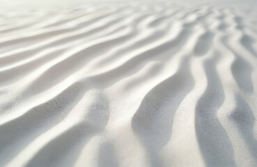 Fototapeta premium Close-up view of light-colored sand dune with textured surface, ripples and waves, wind-eroded. Soft, smooth, crumpled, shiny, silky, rippled sand material. Dune contrast with dark background.