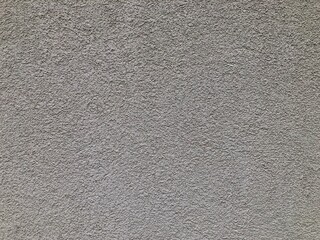 Texture of painted dark gray building facade, close up
