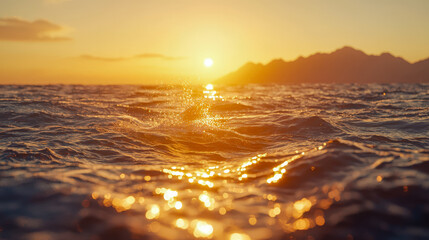 Fototapeta premium Serene sunset over ocean waves with distant mountains