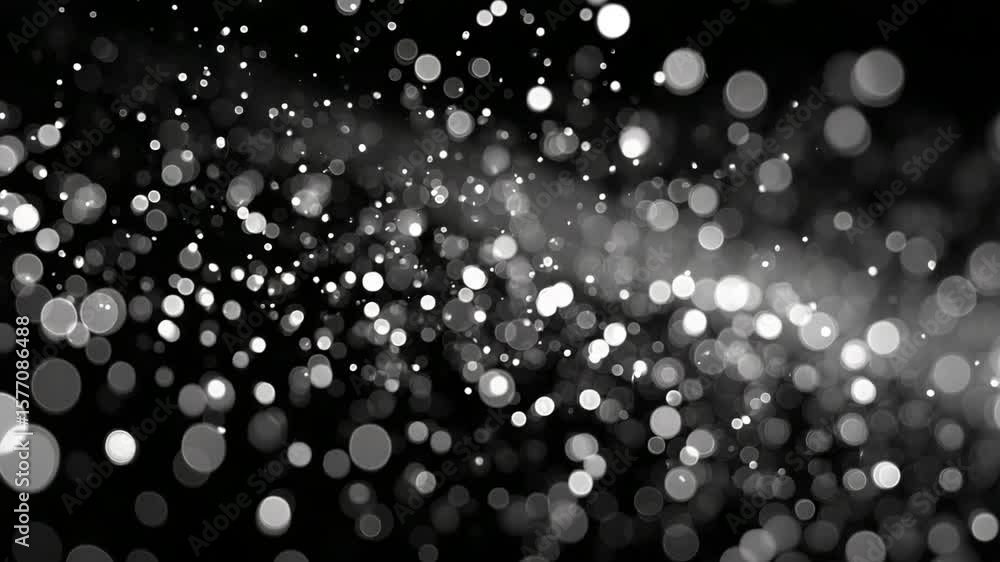 Poster elegant bokeh effect with sparkling light particles across a black background