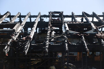 A building is on fire and the roof is black