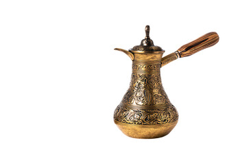 a brass tea pot with a wooden handle