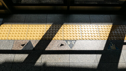 Sunlight and Shadows on a Subway Platform Braille Block