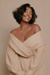 Smiling Black woman in neutral dress with off-shoulder pose photography for social media faceless digital content marketing