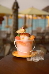 Refreshing slushy cocktail in a bucket, perfect for parties and sharing with friends. This vibrant...