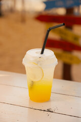 Refreshing pineapple soda with lemon slice. Tropical drink, summer beverage, fizzy, citrus, yellow, cold.
