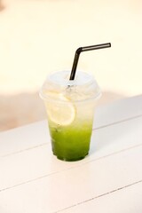 Refreshing kiwi soda with lemon slice. Iced, bubbly drink. Summer beverage. Fruit soda.