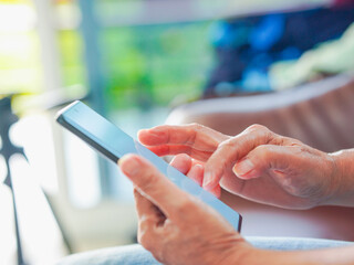 Close up hand people using smartphone browsing internet, business, text or online shopping. Senior...