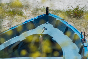 blue wooden fishing boat on the beach