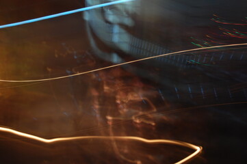 A welder in a factory works with speed and power, creating an artful glow of light and fire as they...