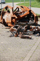 A car is on fire and has been destroyed