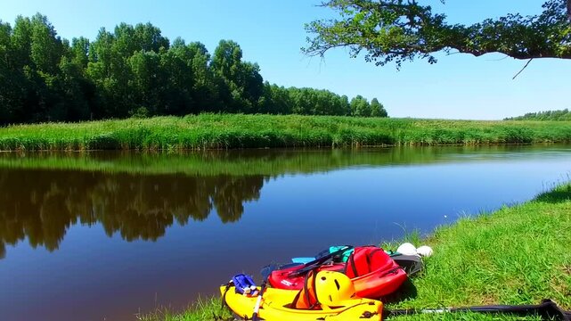 Riverbank with Kayaks under a blue sky