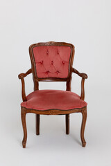 An Elegant Vintage Chair that features Pink Upholstery along with Beautifully Carved Details