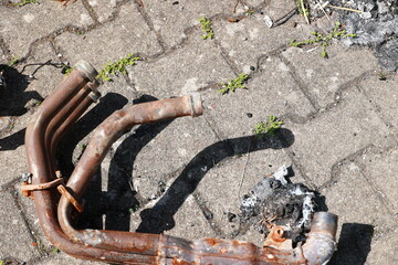 Fototapeta premium A rusted metal pipe is laying on the ground