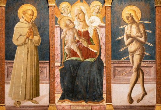 Assisi - The medieval painting of Madonna with St. Francis and Sebastian in Cathedral San Rufino by Matteo da Gualda (1430 - 1507).
