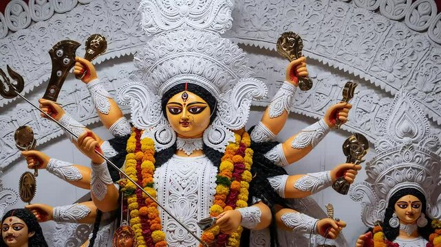 Close Up Statue of Multi Armed Durga Goddess with Ornamented Decoration and Floral Garland Displayed in a Religious Festival