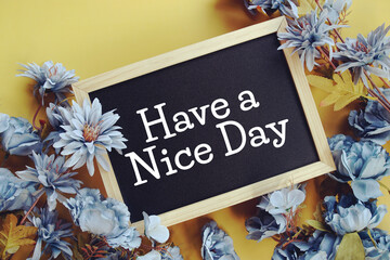 Have a Nice Dayy text with flowers decoration on yellow background