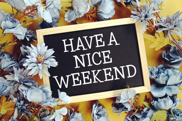 Have a Nice Weekendy text with flowers decoration on yellow background