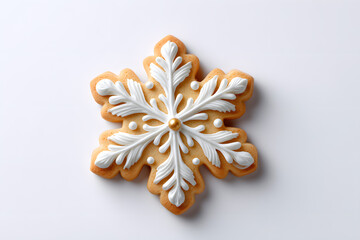 Fototapeta premium Snowflake-shaped gingerbread cookie with intricate white icing. Perfect for holiday baking visuals, Christmas content, and festive food styling.