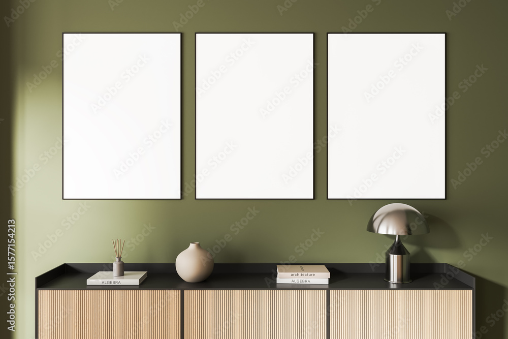 Fototapete minimalist interior with three blank poster mockups on green wall above modern cabinet with decor el