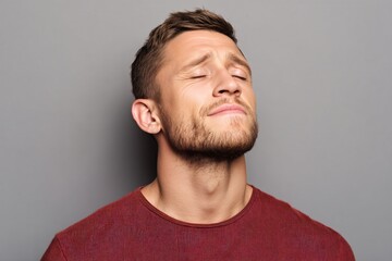 Fototapeta premium Identifying symptoms of eye irritation a close-up of a man exhaling slowly focused on facial expression and tension