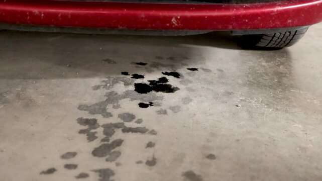 Motor Oil Leak Under a Car on a Garage Floor