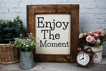 Enjoy The Moment Motivational and Inspirational quotes on wooen background