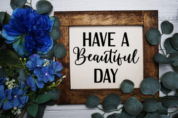 Have a Beautiful Day text with flowers bouquet decoration on wooen background