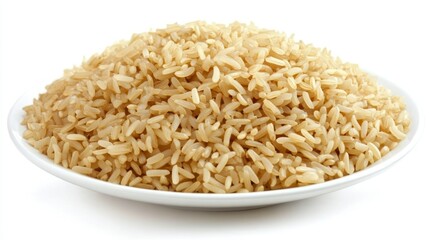A mound of cooked brown rice sits on a simple white plate, isolated on a white background