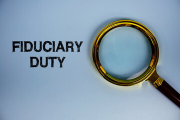 Fiduciary Duty text with magnifying glass on blue background