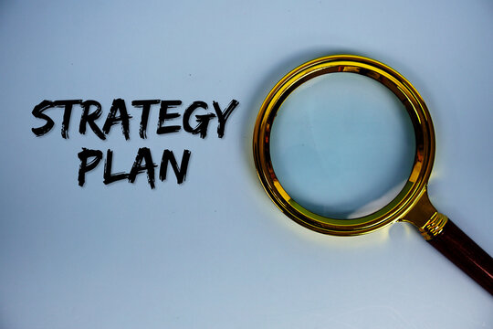 Strategy Plan text with magnifying glass on blue background - Powered by Adobe