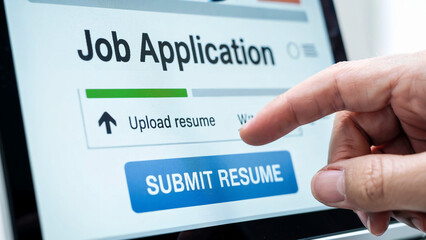 Close up of a human finger pressing the submit resume button on a digital job application form on a screen