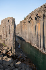 Exploring the breathtaking beauty of Studlagil Canyon in Iceland, where striking vertical basalt...