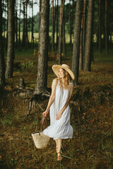 Tourist walking in forest wearing white dress and straw hat