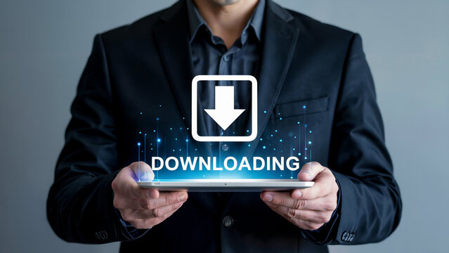 Businessman holding tablet displaying digital download icon and word downloading with glowing blue data streams
