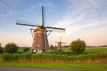 Beautiful view of traditional dutch windmills at the windmill corridor at lake Rottemeren near...