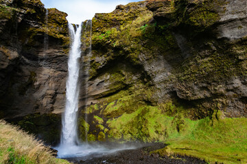 Kvernufoss is a hidden waterfall near Skógafoss, reachable through a short, scenic hike. You can even walk behind it for a magical view.