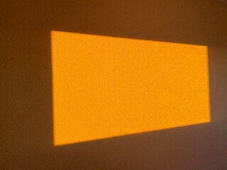 Abstract Warm Sunlight Glow on Textured Wall Background, Illuminated Rectangular Shape for Interior...