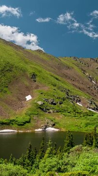 Vertical Timelapse Hyperlapse, Mountain Landscape on Sunny Spring Day, Clouds Moving Above Lake and Peaks