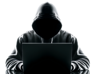 A hacker wearing a hoodie sits at a laptop, isolated against a white background