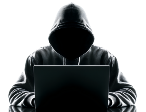 A hacker wearing a hoodie sits at a laptop, isolated against a white background