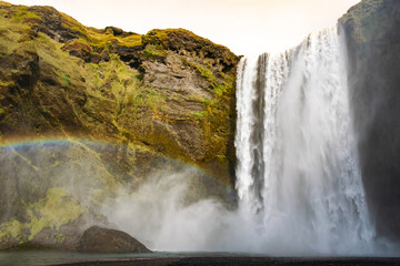 Skógafoss is a mighty waterfall, often seen with rainbows. Follow the trail above to discover many more hidden cascades along the river.