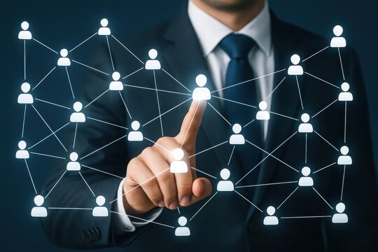 Businessman touching a glowing network of people icons representing connections